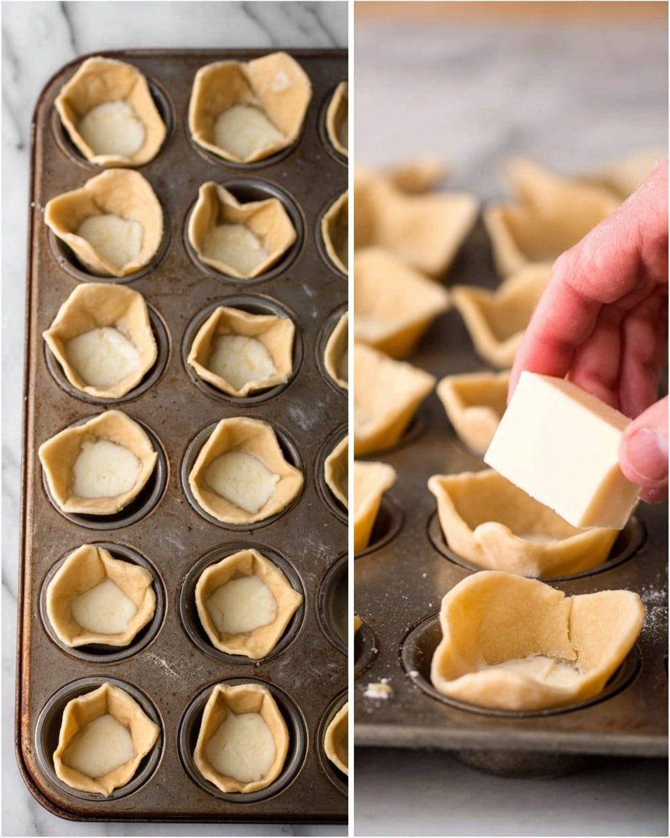 The image shows two views of a dark metal mini muffin tin filled with small dough cups that have been pressed into each mold. The dough is light tan and soft in texture, with uneven edges curling slightly upward inside each cup. On the right side, a woman's hand is placing a wedge of soft white cheese into one of the dough cups, showing the layering of dough first and then cheese on top. The background surface is a white marbled texture photo taken with an iphone --ar 4:5 --v 7