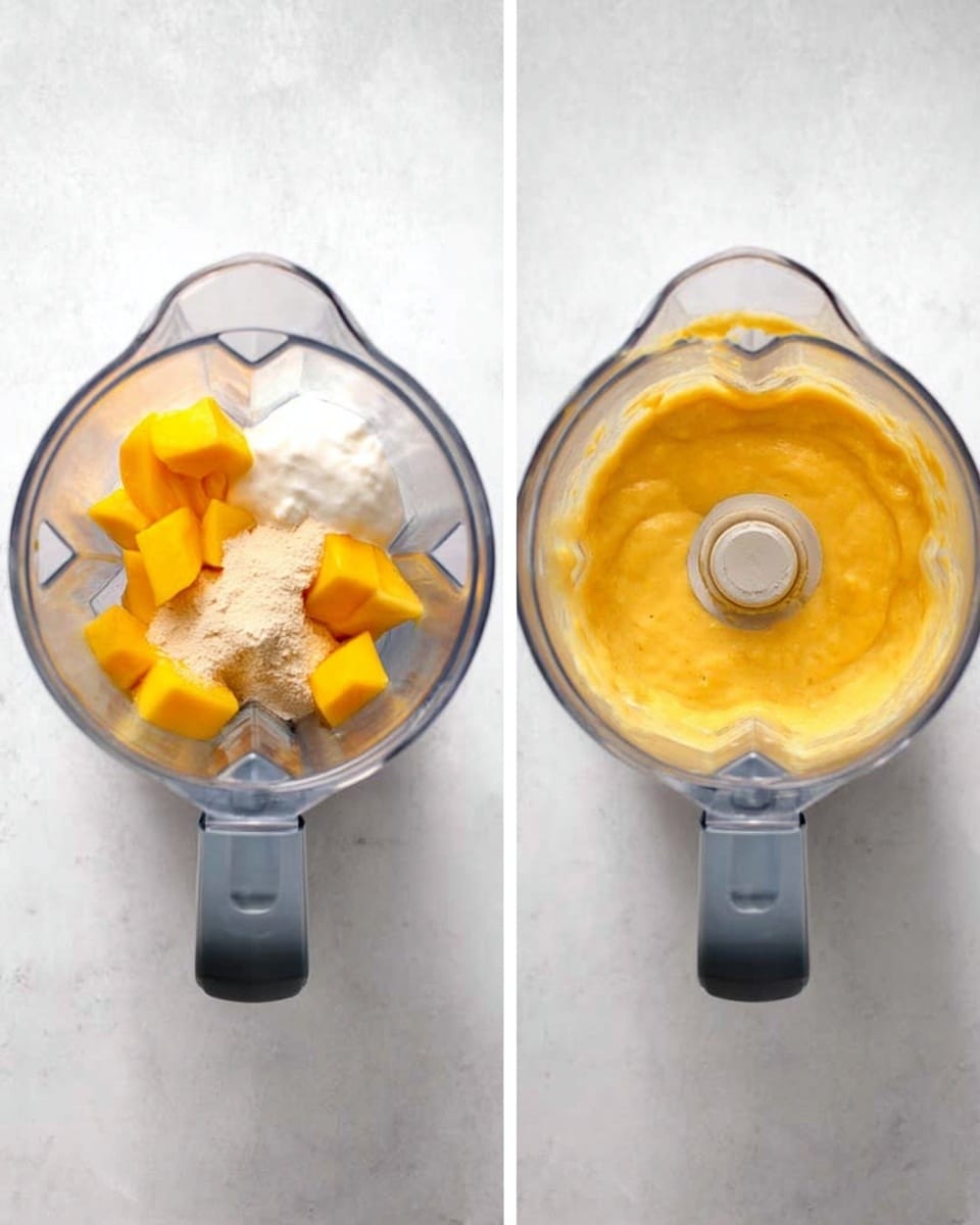 The image shows two top views of a blender placed on a white marbled surface. The first view displays the blender filled with three main ingredients: chunks of bright yellow mango, a dollop of white yogurt, and a scoop of light beige powder, all resting at the bottom. The second view presents the blender after mixing, showcasing a smooth and creamy orange-yellow smoothie filling the container about halfway. The blender is clear and has a gray base. Photo taken with an iphone --ar 4:5 --v 7