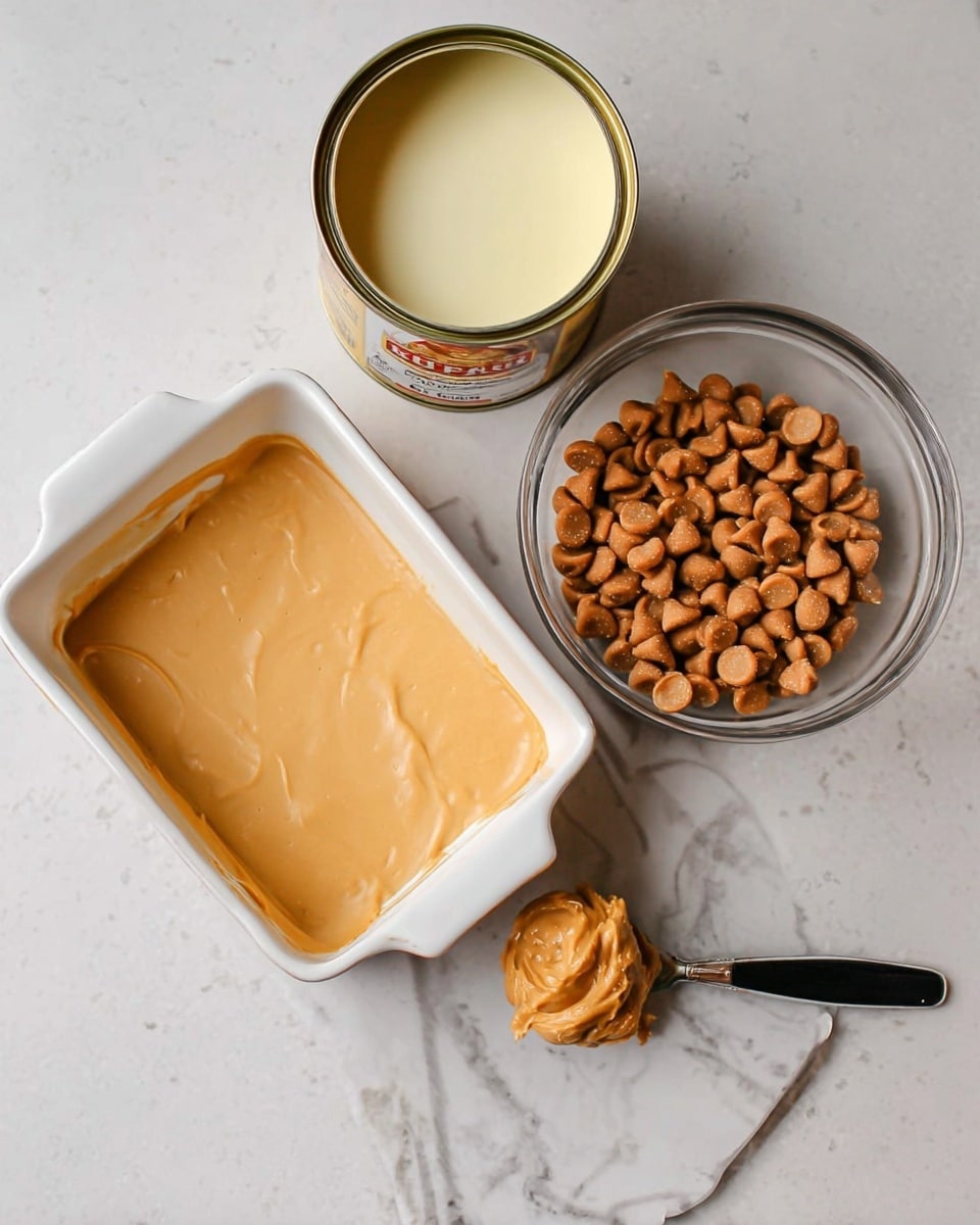 The image shows a white square baking dish in the back on a white marbled surface, with an open can of thick pale yellow condensed milk on the left, a round clear glass bowl filled with light brown peanut butter chips on the right, and a metal spoon with a black handle holding a scoop of creamy light brown peanut butter resting in front of the bowl. photo taken with an iphone --ar 4:5 --v 7