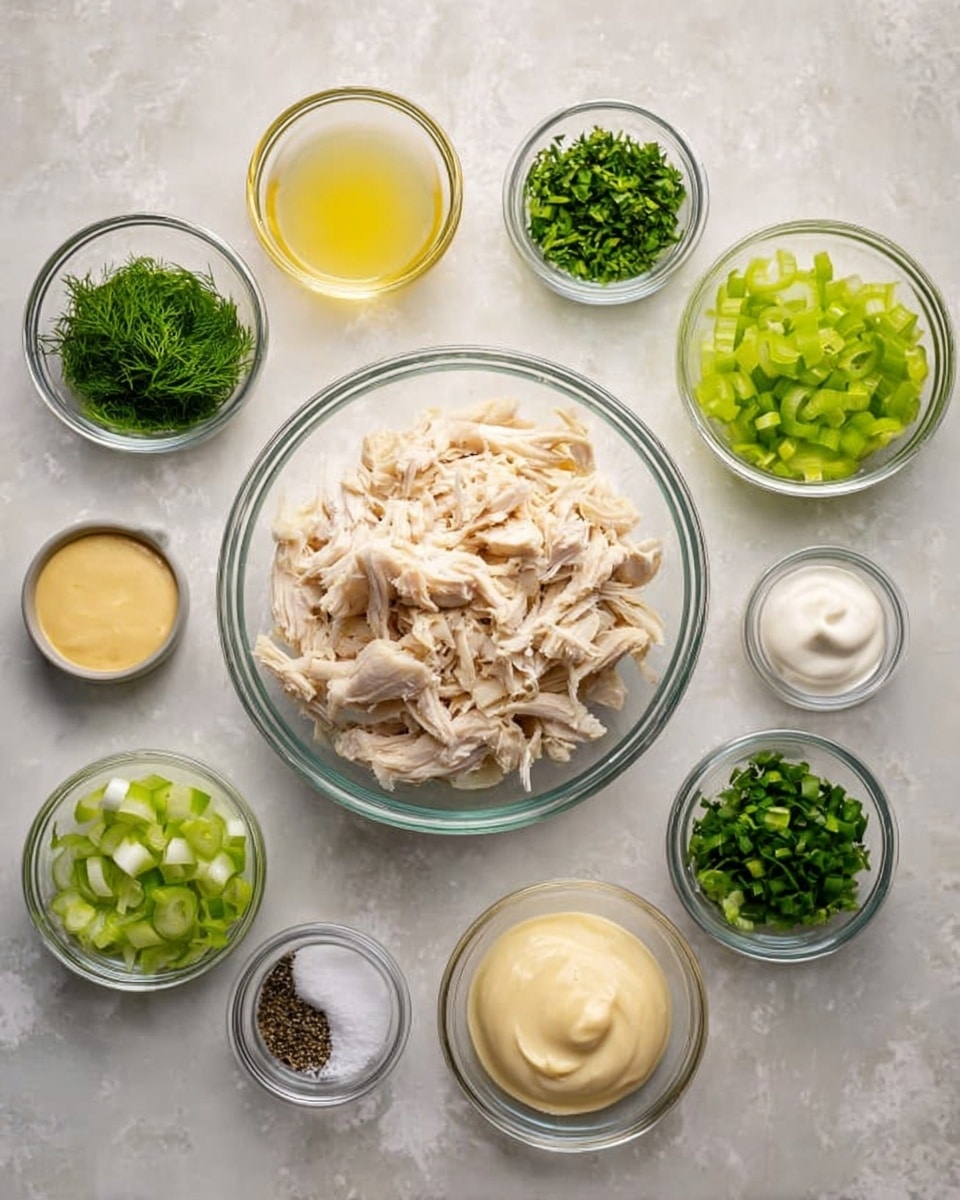 A clear glass bowl filled with shredded white chicken pieces sits in the center, surrounded by smaller clear glass bowls placed evenly around it on a white marbled surface. Starting from the top left and moving clockwise: a bowl with green chopped dill leaves, a bowl of pale yellow liquid, a bowl with chopped light green celery, a bowl of mustard yellow sauce, a bowl of sliced dark green onions, a bowl of chopped dark green parsley, a bowl with white sour cream, a small bowl with white salt, a small bowl with black pepper, a bowl with creamy light yellow mayonnaise, and a small bowl of white salt. The different textures range from creamy sauces to soft shredded chicken and fresh chopped herbs, all neatly arranged. Photo taken with an iphone --ar 4:5 --v 7