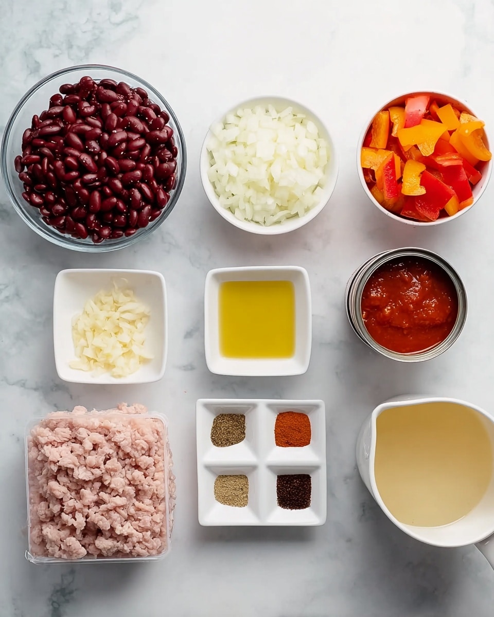 The image shows eight bowls and one container arranged on a white marbled surface. Starting from the top left, there is a clear glass bowl filled with dark red kidney beans. Next, a white bowl contains chopped white onions and bright orange bell peppers. To the right of this bowl, a silver open can displays thick red tomato sauce inside. Moving down to the center, there is a small white bowl filled with light yellow oil. To its right, a small square white bowl holds four different ground spices in four color blocks: light brown, dark brown, black speckles, and deep red. Below, another square white bowl contains tiny pieces of crushed garlic, pale yellow in color. To the left of that, a sealed plastic container holds raw ground turkey, pale pink with a ridged texture. Lastly, at the bottom right, a large white measuring cup contains a pale yellow broth. The lighting is soft and even, and the photo was taken with an iphone --ar 4:5 --v 7
