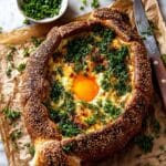 Sesame Khachapuri with Herb-Infused Cheese, Egg, and Honey Butter Sauce Recipe