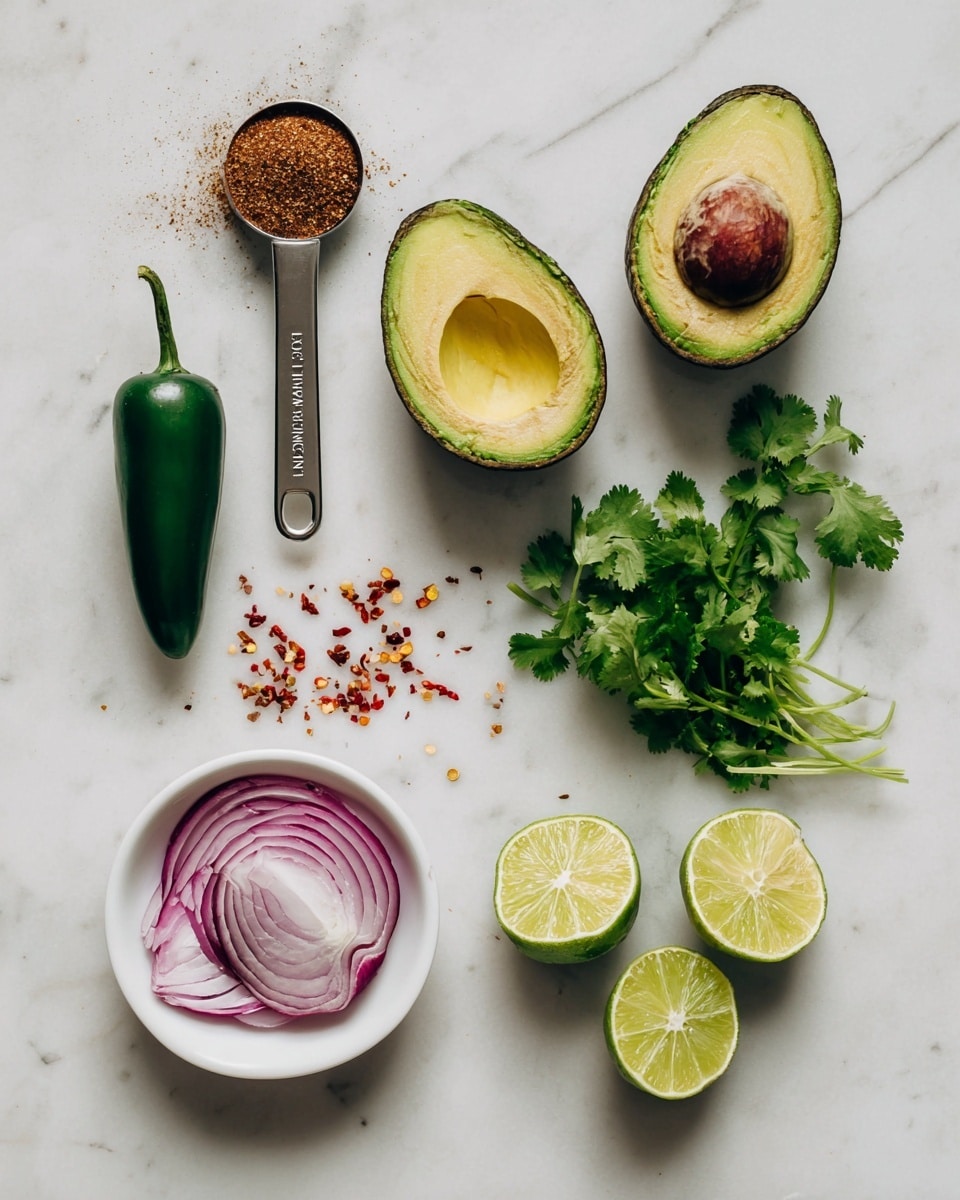 The image shows fresh ingredients placed neatly on a white marbled surface: a metal measuring spoon with brown spice powder lies on the left, next to a shiny, dark green jalapeño. Beside it, there is a ripe avocado cut in half with its seed in the top half and the bottom half empty and bright green inside. To the right are sprigs of fresh cilantro with vibrant green leaves. Below, a white bowl holds red chili flakes, a halved red onion with white and purple layers is on the bottom left, and two lime halves with juicy, light green flesh sit at the bottom right. Photo taken with an iphone --ar 4:5 --v 7
