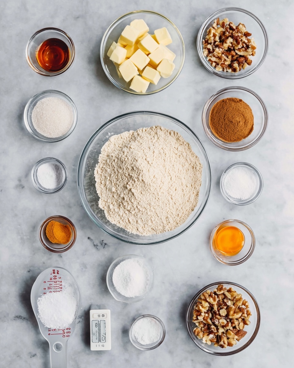 A top view of various ingredients placed separately on a white marbled surface. At the bottom center is a large clear glass bowl filled with light beige flour. To its right is a small glass bowl with brown sugar, and above that another small glass bowl with chopped nuts. Above the flour bowl to the left is a clear glass bowl with cubes of pale yellow butter. Scattered around are smaller bowls containing salt, white sugar, cinnamon powder, liquid honey, orange zest, and vanilla extract. A measuring cup with granulated sugar is on the left, and a small bowl of white powder is nearby. The layout is neat and organized, showing all ingredients clearly. Photo taken with an iphone --ar 4:5 --v 7