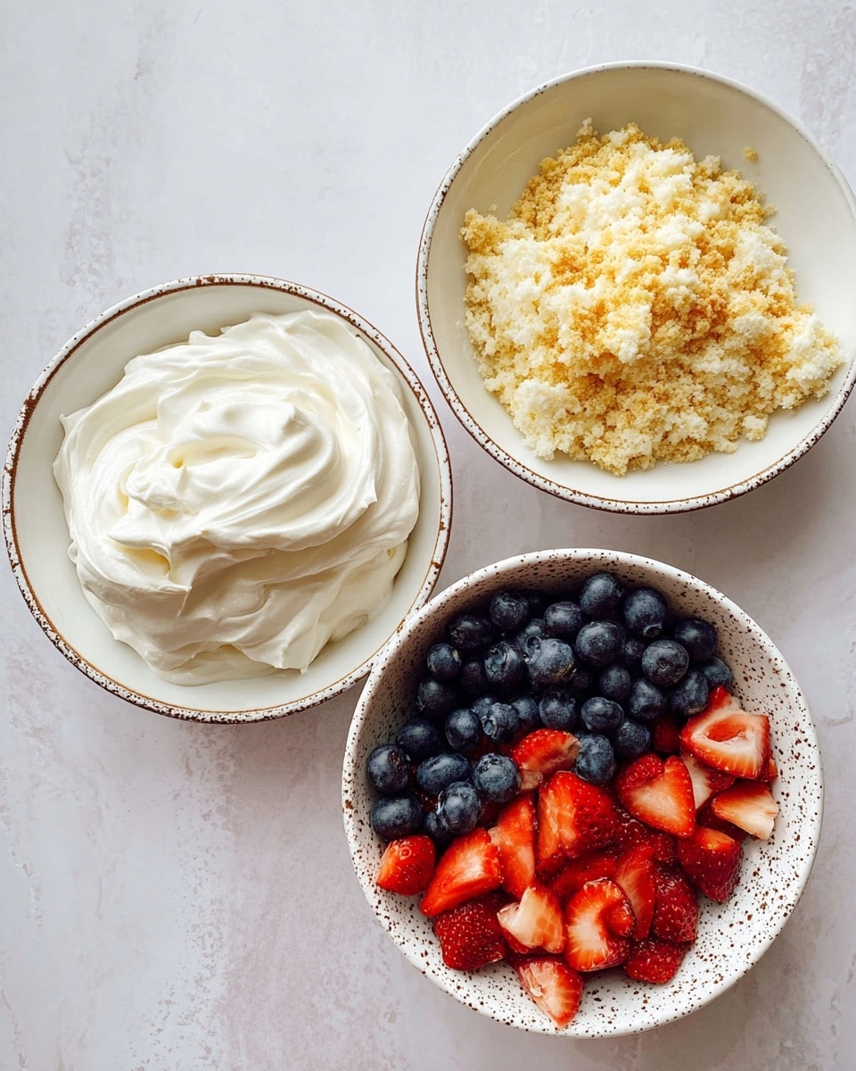 The image shows three white bowls with brown speckled edges on a white marbled surface. One bowl is filled with fluffy white whipped cream that has smooth swirls and a soft texture. Another bowl contains light yellow cake crumbs mixed with some golden brown bits, giving it a crumbly and uneven texture. The third bowl is a white bowl filled with fresh fruits, half with dark blue blueberries that are smooth and round, and the other half with red strawberry pieces that are shiny and cut into small chunks. photo taken with an iphone --ar 4:5 --v 7
