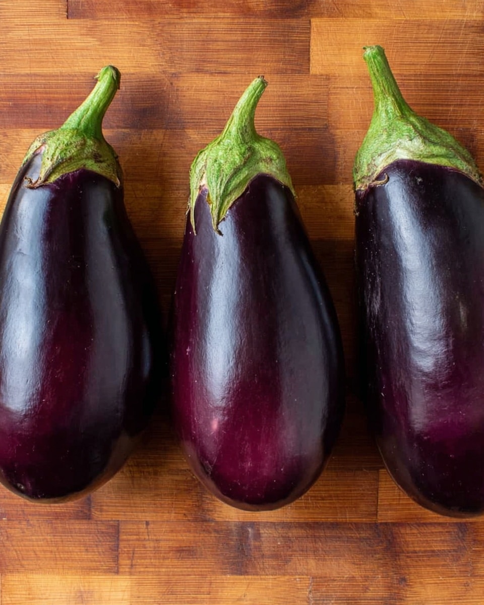 The image shows three whole eggplants placed side by side on a wooden board. Each eggplant has a deep purple, smooth, and slightly shiny skin with green stems attached at the top. The eggplants are arranged in a row, evenly spaced with their stems pointing upward. The wooden board has a warm brown color with a checker pattern and visible wood grain texture. photo taken with an iphone --ar 4:5 --v 7