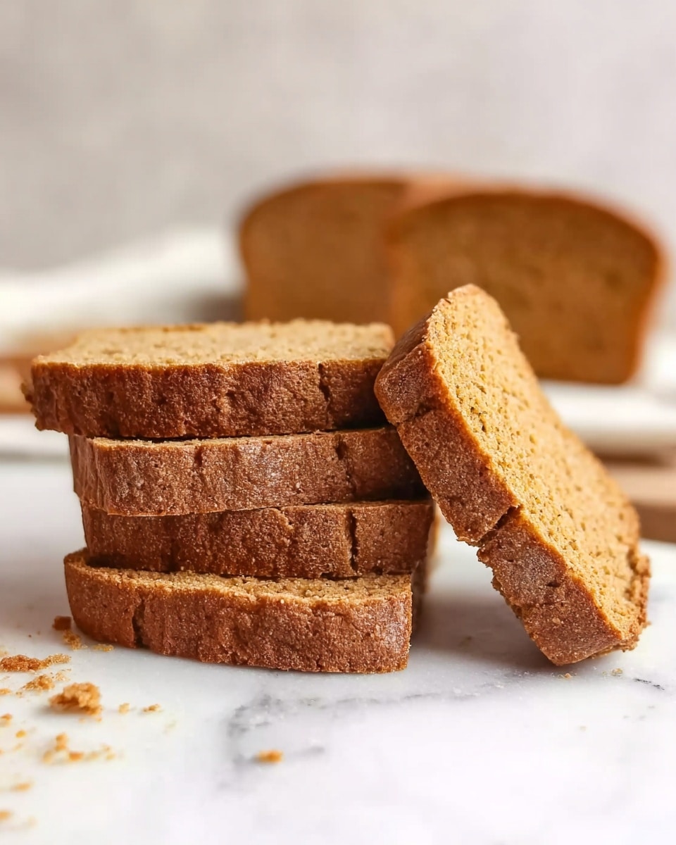 The image shows four brown slices of bread stacked on top of each other with rough edges and a crumbly texture, placed on a white marbled surface. There is one slice standing upright on its side next to the stack. In the background, more slices and a larger piece of bread can be seen blurred. The bread looks soft inside with a darker brown crust around the edges. photo taken with an iphone --ar 4:5 --v 7