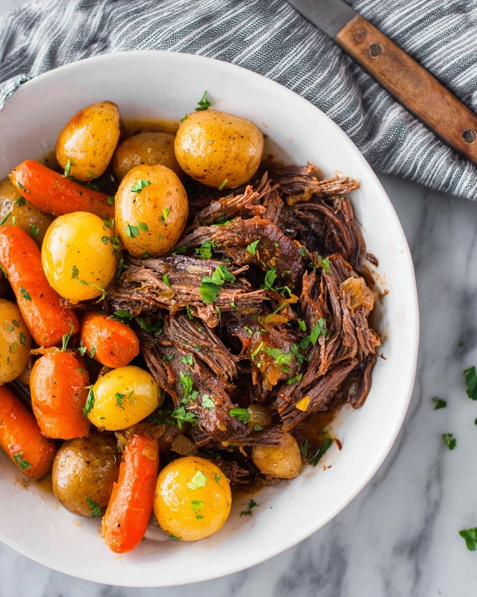 A white bowl filled with a mix of shredded dark brown beef layered at the bottom, topped with bright orange carrots and small shiny golden potatoes scattered around. The beef has a moist texture with some pieces showing light onions and herbs mixed in. The vegetables have a slight glaze and are sprinkled with fresh green chopped parsley for color. The bowl sits on a white marbled surface with a knife with a wooden handle resting nearby over a gray and white striped cloth. photo taken with an iphone --ar 4:5 --v 7