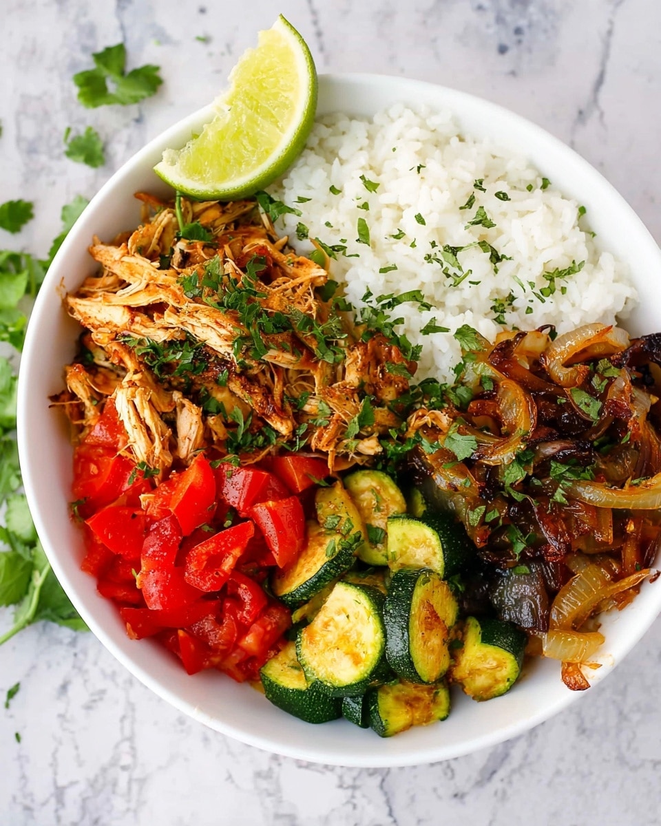 A white bowl on a white marbled surface holds a colorful meal divided into four sections. One section has cooked white rice with a soft, fluffy texture. Next to it is shredded, cooked chicken with a golden brown, slightly crispy look, topped with chopped green herbs and a lime wedge tucked on the side. Another section contains chopped fresh red tomatoes, bright and juicy in appearance. The final section holds a mix of cooked zucchini slices and caramelized onions, showing a mix of yellow-green and deep brown colors, garnished with chopped herbs. Photo taken with an iphone --ar 4:5 --v 7