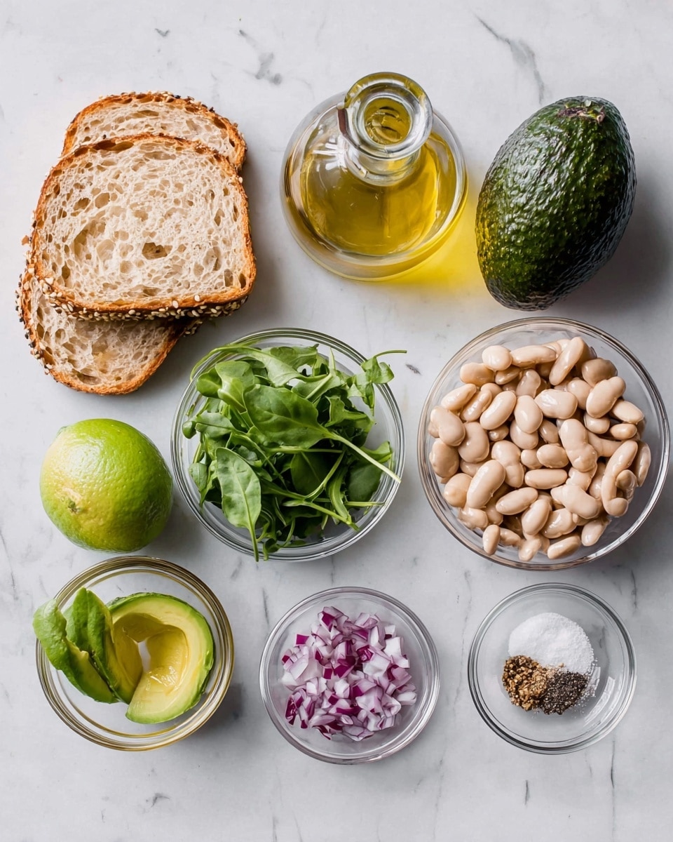 The image shows ingredients on a white marbled surface: two slices of light brown bread with seeds on the edges, a whole dark green avocado, a whole bright green lime, a glass bottle of golden olive oil, a glass bowl of small dark green leaves, a glass bowl of white beans, a small glass bowl with chopped purple onions, and another small glass bowl with three seasonings—black pepper, white salt, and light brown powder. photo taken with an iphone --ar 4:5 --v 7