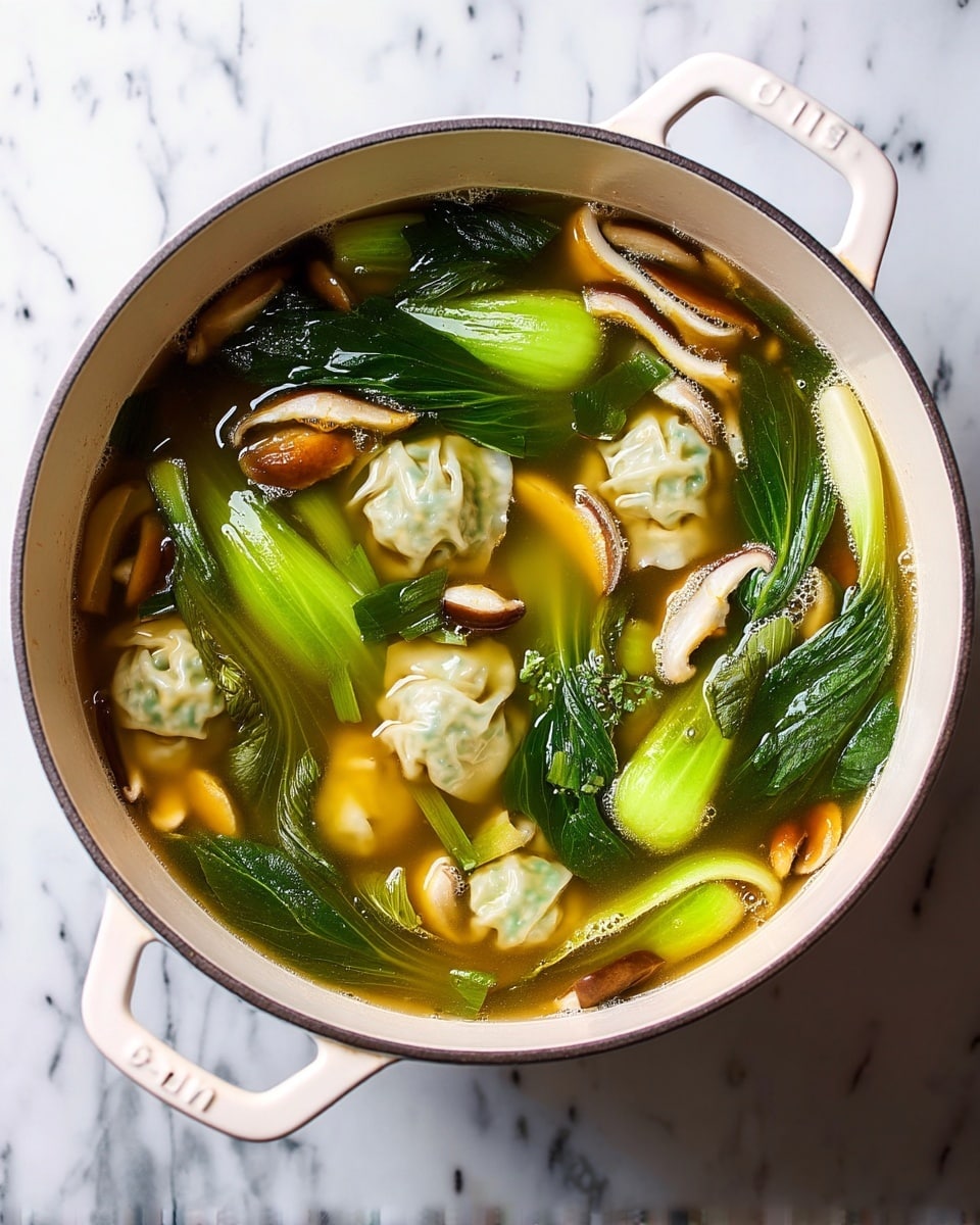 A white pot filled with clear golden broth containing three main layers: light green bok choy leaves and stems floating on the surface, thin slices of light brown and white shiitake mushrooms scattered throughout, and pale green dumplings with crinkled edges partially submerged below the vegetables and mushrooms. The pot is placed on a white marbled surface. photo taken with an iphone --ar 4:5 --v 7